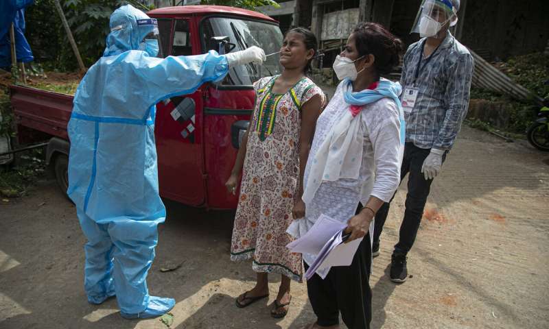 An Indian health worker takes a nasal swab sample to test for COVID-19 during a door to door test drive in Gauhati, India, Saturday, Aug. 29, 2020. India has the third-highest coronavirus caseload after the United States and Brazil, and the fourth-highest death toll in the world. (AP Photo/Anupam Nath) India records highest daily increase in virus cases globally