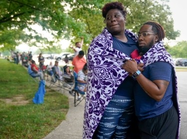 Whitney Maddox and DeShaun Bradford stand in line with hundreds of others outside a career center in Frankfort, Kentucky, hoping for assistance with their unemployment claim, June 18, 2020, photo by Bryan Woolston/Reuters