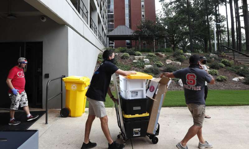 In this July 31, 2020, file photo, college students begin moving in for the fall semester at N.C. State University in Raleigh, N.C. Colleges are eager to share their reopening plans as they encourage students to return to campus. But fewer of them are talking about the elephant in the room: what happens if they need to shut down again.(AP Photo/Gerry Broome, File) Will you get a refund if COVID-19 closes your campus?