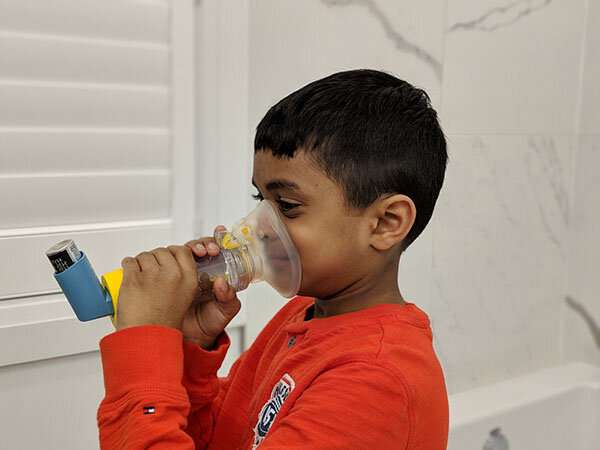 Child using an age-appropriate valved spacer device with an asthma inhaler. They should be used together for children to ensure the medication is properly delivered to the lungs. Credit: Lawson Health Research Institute Population-based study shows air pollution exposure contributes to childhood asthma