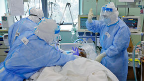 Medical workers in China take care of a COVID-19 patient in 2020