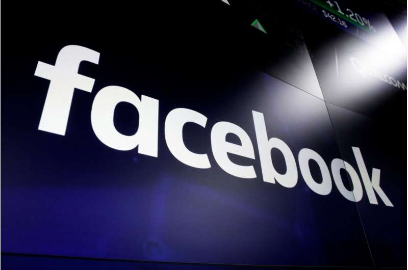 In this March 29, 2018, file photo, the Facebook logo on a screen at Nasdaq in Time Square, New York. Australia's Parliament will debate making Google and Facebook pay for news after a Senate committee on Friday, Feb. 12, 2021 recommended no changes to the world-first draft laws. (AP Photo/Richard Drew, File) Australia news media 'large and small' discuss Google deals