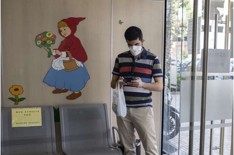 36 year-old Vasilis Tsipiras waits to receive his first dose of the of the AstraZeneca COVID-19 vaccine, at a vaccination center in Piraeus, near Athens, Thursday, April 29, 2021. Greece's health minister says any adult who wants to be vaccinated against COVID-19 will be able to do so by the end of June, as the country ramps up its vaccination drive. (AP Photo/Petros Giannakouris) Greece: All adults can receive COVID-19 vaccines before July