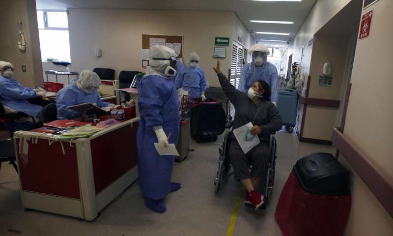 Recovering COVID-19 patient Marisol Ortiz Bernal waves goodbye to the health workers that cared for her at the Mexico City Ajusco Medio General Hospital, Wednesday, Dec. 2. 2020. Mexico continues to report an increase in the number of coronavirus cases, with Mexico City continuing to report the biggest portion of the surge in cases. (AP Photo/Marco Ugarte) Mexico City hospitals are filling up, but so are the streets