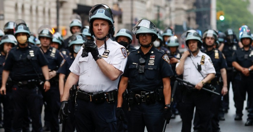 Police officers stand guard across Central Park West during a protest against the death in Minneapolis police custody of George Floyd, in New York City, June 5, 2020, photo by Mike Segar/Reuters