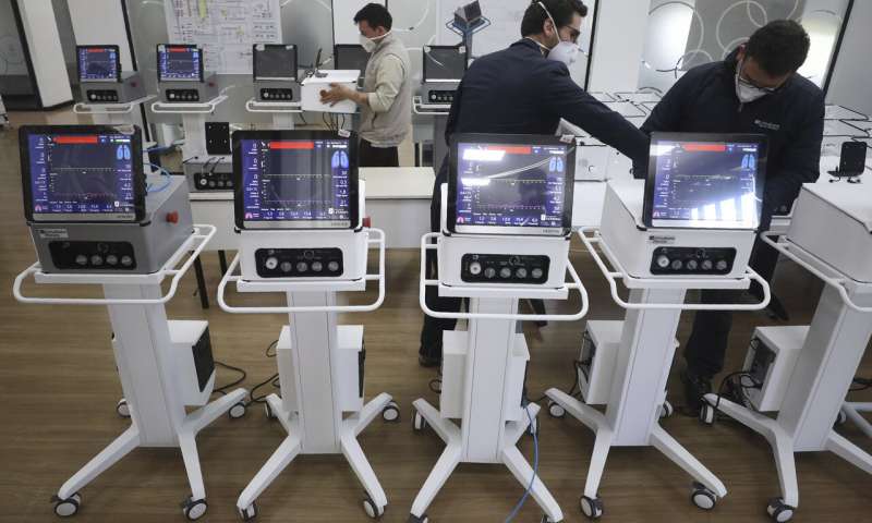 Engineers from La Sabana University demonstrate low-cost ventilators for patients with COVID-19 in Bogota, Colombia, Monday, July 6, 2020. The machine called the Heron looks like many other ventilators used to treat COVID-19 patients, but this device costs about $4,000, a fifth of the price of ventilators imported from China, and it's made in Colombia, where some hospitals have been overwhelmed by coronavirus patients. (AP Photo/Fernando Vergara) Colombia turns to emergency ventilators to treat COVID-19