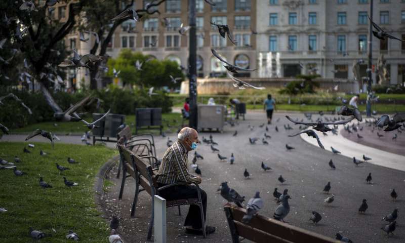A man wearing a face mask to prevent the spread of coronavirus sits in a square in Barcelona, Spain, Wednesday Sept. 23, 2020. Spain is struggling to contain a second wave of the virus which has killed at least 30,000 people according to the country's health ministry. (AP Photo/Emilio Morenatti) Spain says 'tough weeks' ahead as Madrid hit hard by virus