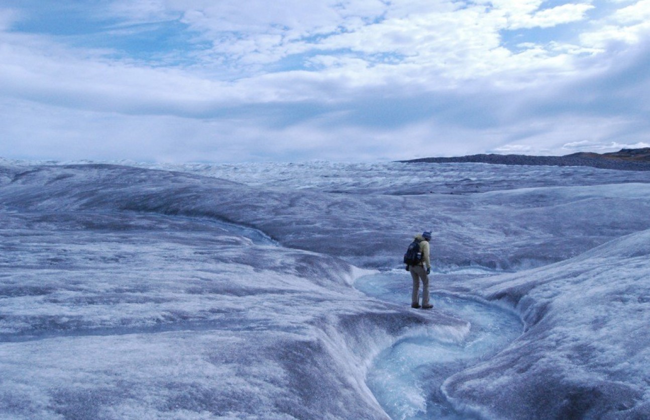 An illustration of a melting ice cap with a person walking on it