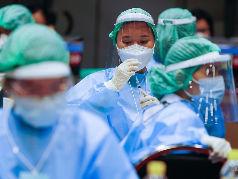A health worker prepares a dose of the CoronaVac vaccine at a vaccination center in Nonthaburi province, outskirts of Bangkok.
