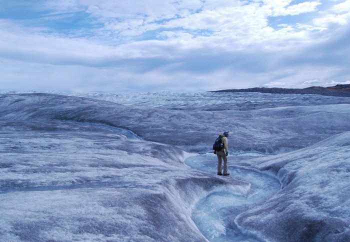 An illustration of a melting ice cap with someone walking on it