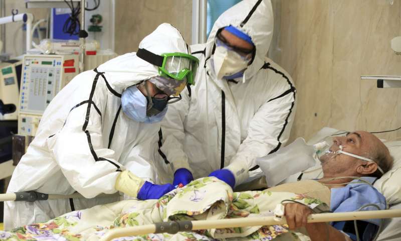 In this Oct. 14, 2020, photo provided by the Iranian Health Ministry, medics tend to a COVID-19 patient at the Shohadaye Tajrish Hospital in Tehran, Iran. Iran is confronting a new surge of infections that is filling hospitals and cemeteries alike. (Akbar Badrkhani/Iranian Health Ministry via AP) Over 3 million cases of coronavirus reported in Mideast