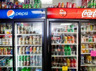 Cans of soda are displayed in a case at Kwik Stops Liquor in San Diego, California, February 13, 2014