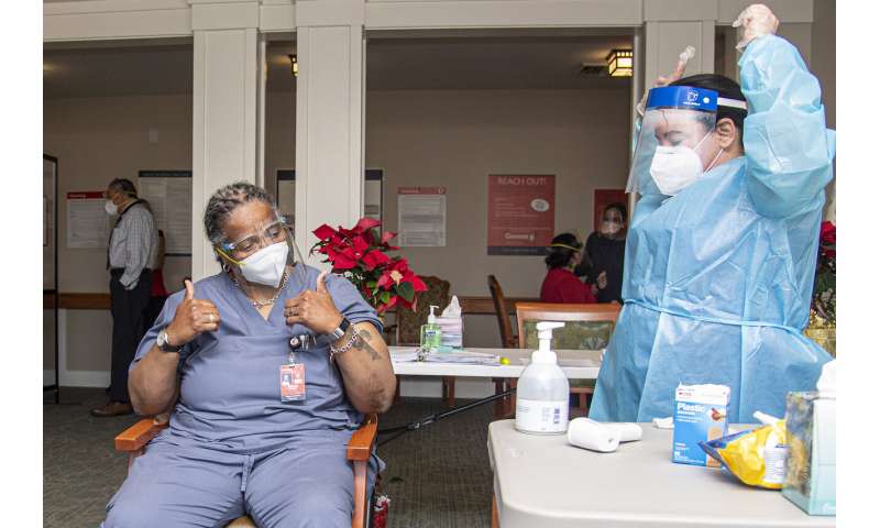 Pharmacist Nadine M. Mackey, right, and registered nurse Gloria Campbell, center, react after Campbell received a COVID-19 vaccination at PowerBack Rehabilitation, in Phoenixville, Pa., Monday, Dec. 28, 2020. (Jose F. Moreno/The Philadelphia Inquirer via AP) More COVID-19 vaccines in the pipeline as US effort ramps up
