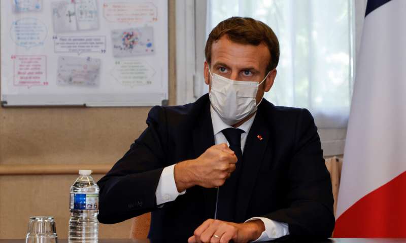 French President Emmanuel Macron chairs a meeting with the medical staff of the Rene Dubos hospital center, in Pontoise, outside Paris, Friday Oct. 23, 2020. French Prime Minister Jean Castex said Thursday a vast extension of the nightly curfew that is intended to curb the spiraling spread of the coronavirus, saying "the second wave is here." The curfew imposed in eight regions of France last week, including Paris and its suburbs, is being extended to 38 more regions and Polynesia, (Photo by Ludovic Marin, Pool via AP) France surpasses 1 million confirmed virus cases amid spike