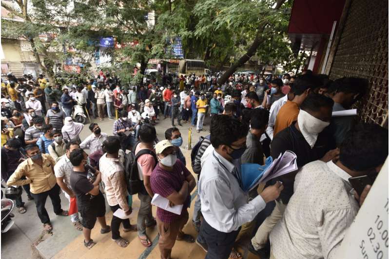 In this April 8, 2021 file photo, people wait in queues outside the office of the Chemists Association to demand necessary supply of the anti-viral drug Remdesivir, in Pune, India. As India faces a devastating surge of new coronavirus infections overwhelming the health care system, people are turning to desperate measures to keep loved ones alive. (AP Photo, File) Indians turn to black market, unproven drugs as virus surges
