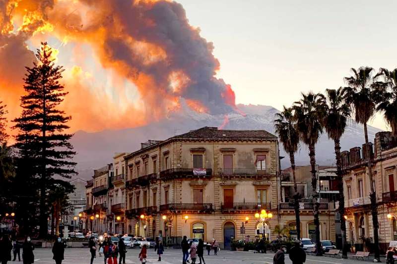 Mount Etna, Europe's most active volcano, spews ash and lava, as seen from Catania, southern Italy, Tuesday, Feb. 16, 2021. Mount Etna in Sicily, southern Italy, has roared back into spectacular volcanic action, sending up plumes of ash and spewing lava. (Davide Anastasi/LaPresse via AP) Sicilian village cleans up ash, stones from Mt Etna eruption