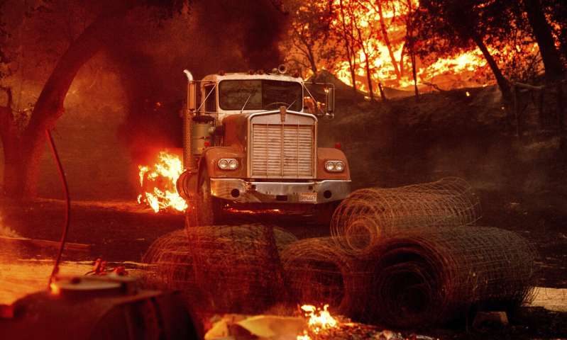 Flames from the Glass Fire burn a truck in a Calistoga, Calif., vineyard Thursday, Oct. 1, 2020. (AP Photo/Noah Berger) Better weather won't keep California from grim fire landmark