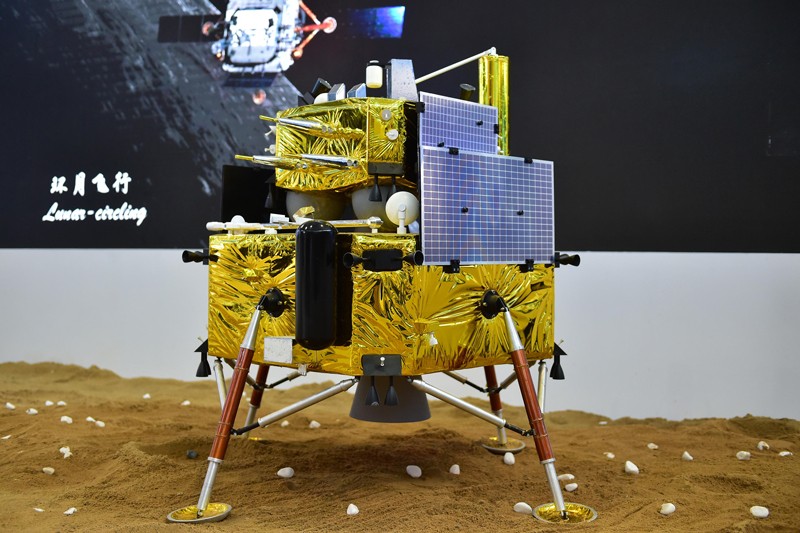 A gold-coloured landing craft with four legs and solar panels.