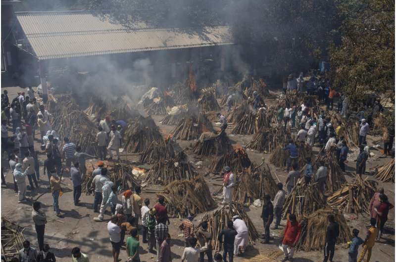 In this April 24, 2021, file photo, multiple funeral pyres of those who died of COVID-19 burn at a ground that has been converted into a crematorium for the mass cremation of coronavirus victims, in New Delhi, India. India crossed a grim milestone Wednesday, April 28, 2021 of 200,000 people lost to the coronavirus as a devastating surge of new infections tears through dense cities and rural areas alike and overwhelms health care systems on the brink of collapse. (AP Photo/Altaf Qadri, File) India tops 200,000 dead as virus surge breaks health system