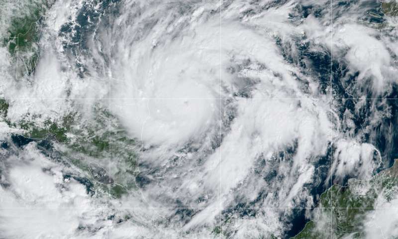 This GeoColor satellite image taken Monday, Nov. 2, 2020, at 1 p.m. EDT, and provided by NOAA, shows Hurricane Eta in the Gulf of Mexico approaching the border of Honduras and Nicaragua. New Hurricane Eta quickly gained force Monday as it headed for Central America on the verge of becoming a major hurricane, threatening massive flooding and landslides across a vulnerable region. (NOAA via AP) Hurricane Eta threatens to bring flooding, storm surge