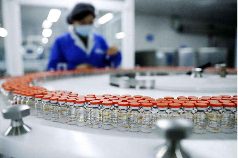 In this Dec. 23, 2020, file photo released by China's Xinhua News Agency, a Sinovac worker checks the labeling on vials of COVID-19 vaccines on a packaging line in Beijing. With just four of China's many vaccine makers claiming they are able to produce at least 2.6 billion doses this year, a large part of the world's population will end up inoculated not with Western vaccines boasting headline-grabbing efficacy rates, but with China's traditionally made shots. (Zhang Yuwei/Xinhua via AP, File) Chinese vaccines sweep much of the world, despite concerns