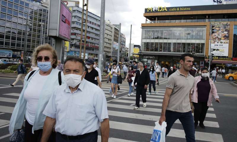 People wearing face masks to protect against the spread of coronavirus, walk in the main Kizilay Square, in Ankara, Turkey, Tuesday, June 16, 2020. Turkey has made the wearing of face masks mandatory in five more provinces, following an uptick in COVID-19 cases. Health Minister Fahrettin Koca tweeted early Tuesday that the wearing of masks is now compulsory in 42 of Turkey's 81 provinces.(AP Photo/Burhan Ozbilici) Turkey makes masks mandatory in Istanbul, 46 other provinces