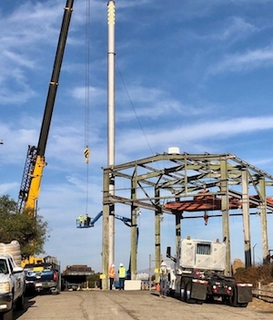 Photo: A crew tears down a stack attached to Building 4022 at the Radioactive Materials Handling Facility (RMHF) at the Energy Technology Engineering Center (Credit: DOE)