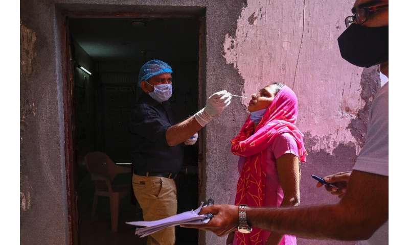 A medical worker performs a Covid test in Ghaziabad, India on April 3, 2021