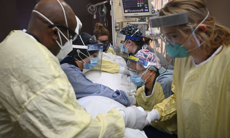 In this Monday, Dec. 7, 2020, file photo, critical care nurses and respiratory therapists flip a patient with COVID-19 upright at North Memorial Health Hospital in Robbinsdale, Minn. Virtually every state is reporting surges in cases and deaths. (Aaron Lavinsky/Star Tribune via AP, File) US virus deaths hit record levels with the holidays ahead