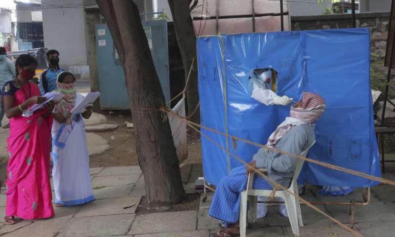 A health worker takes a nasal swab sample to test for COVID-19 in Hyderabad, India, Saturday, Aug. 22, 2020. India has the third-highest caseload after the United States and Brazil, and the fourth-highest death toll in the world. (AP Photo/Mahesh Kumar A.) India's virus caseload tops 3 million as disease moves south