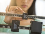 Woman adjusts weight scale