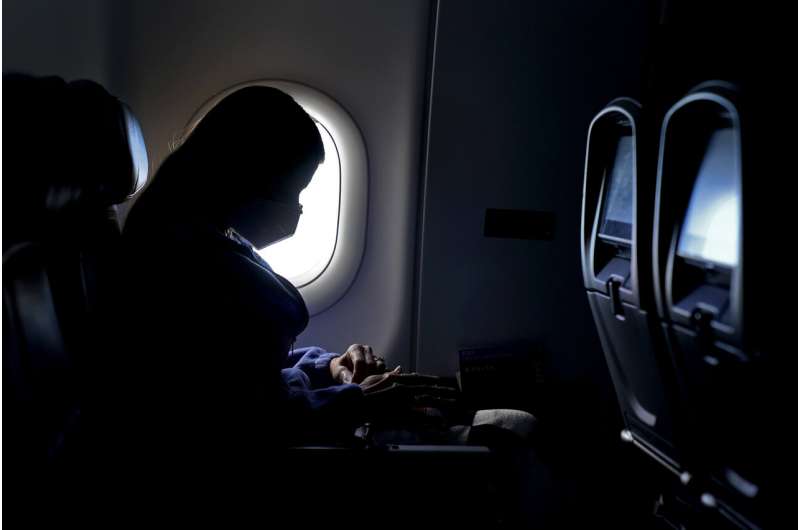 In this Wednesday, Feb. 3, 2021, file photo, a passenger wears a face mask she travels on a Delta Air Lines flight after taking off from Hartsfield-Jackson International Airport in Atlanta. Airlines are dropping some of the temporary service changes they made during the early part of the coronavirus pandemic. Delta is the only airline still blocking middle seats, but there's no guarantee that'll continue past April 30. (AP Photo/Charlie Riedel, File) Airlines return to old ways; Southwest drops boarding change