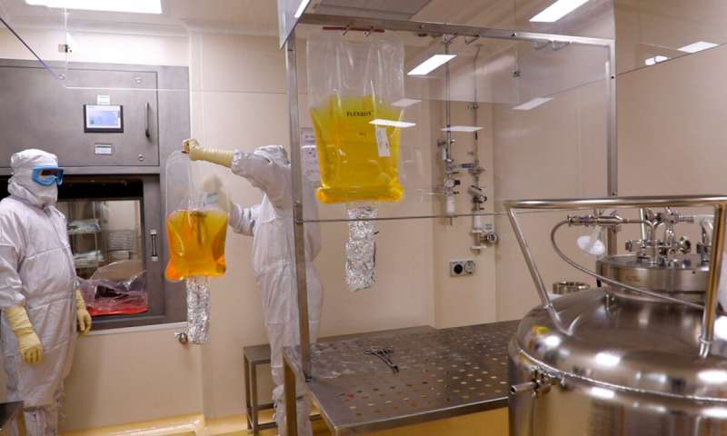In this undated photograph provided by Serum Institute of India, an employee at the institute works at their facility in Pune, India. The institute is further increasing its capacity for the coronavirus: from being able to make 1.5 billion shots in a year right now, to over 2.5 billion doses by the end of 2021. (Serum Institute of India via AP) Poor countries face long wait for vaccines despite promises
