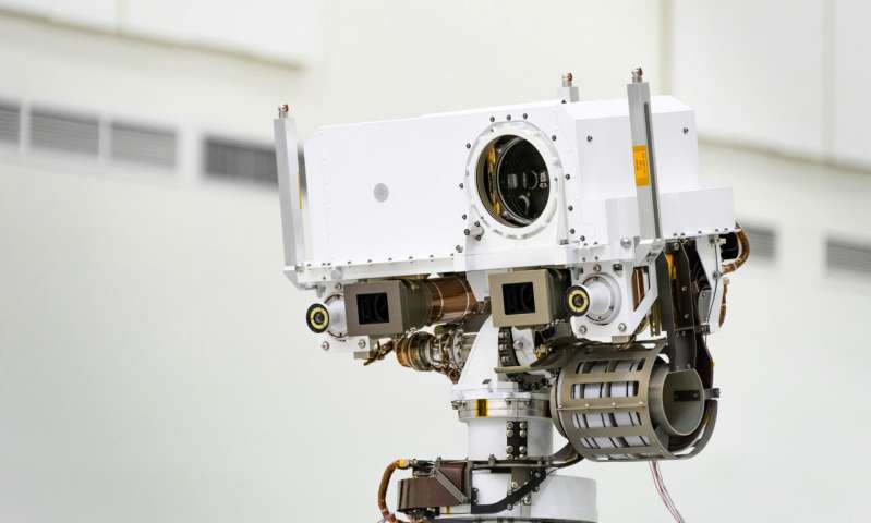 This July 23, 2019 photo made available by NASA shows the head of the Mars rover Perseverance's remote sensing mast which contains the SuperCam instrument in the large circular opening, two Mastcam-Z imagers in gray boxes, and next to those, the rover's two navigation cameras, at the Jet Propulsion Laboratory in Pasadena, Calif. The robotic vehicle will hunt for rocks containing biological signatures, if they exist. (NASA/JPL-Caltech via AP) Look out, Mars: Here we come with a fleet of spacecraft