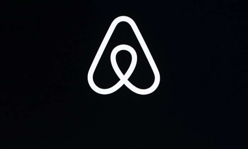 This Feb. 22, 2018, file photo shows an Airbnb logo during an event in San Francisco. On Wednesday, Aug. 19, 2020, Airbnb filed preliminary paperwork for selling stock on Wall Street, undaunted by a global pandemic that has taken some wind out of its home-sharing business. (AP Photo/Eric Risberg, File) Airbnb files preliminary paperwork for public stock offering